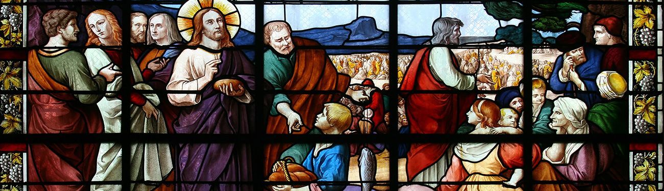 A stained-glass window shows Jesus and his apostles.