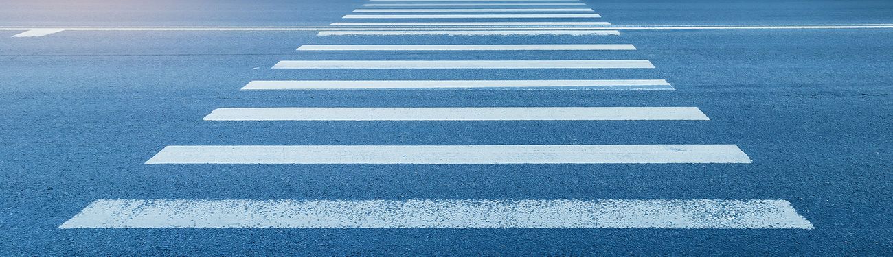 A close up of a crosswalk on a city road.
