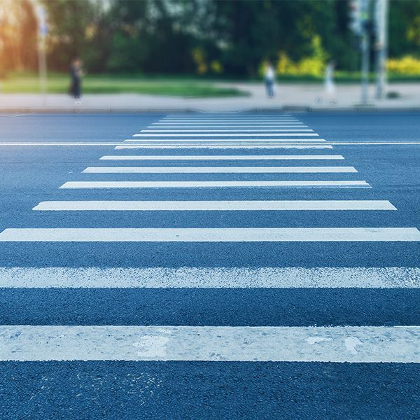 A close up of a crosswalk on a city street.