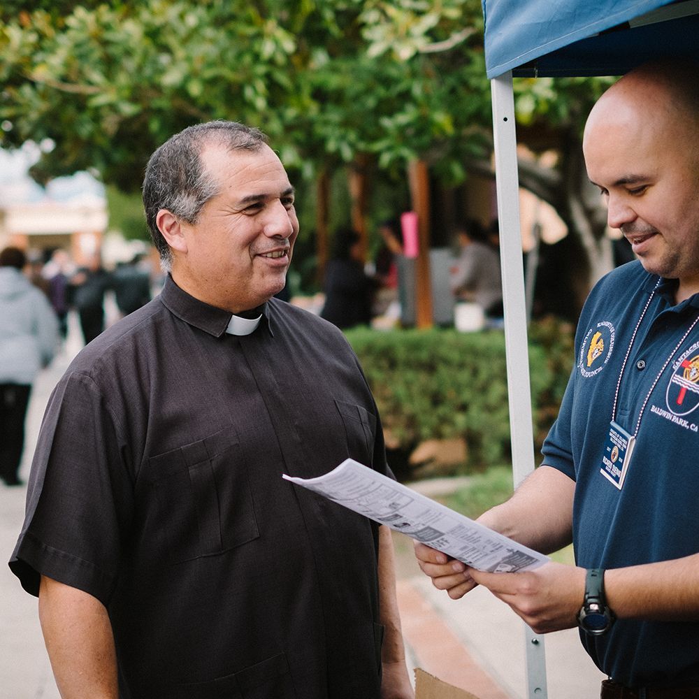 A parish priest talking to parishioners