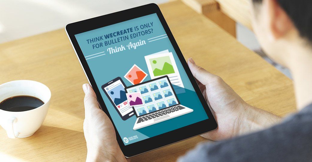 A man is holding a tablet with a picture of a laptop on it.