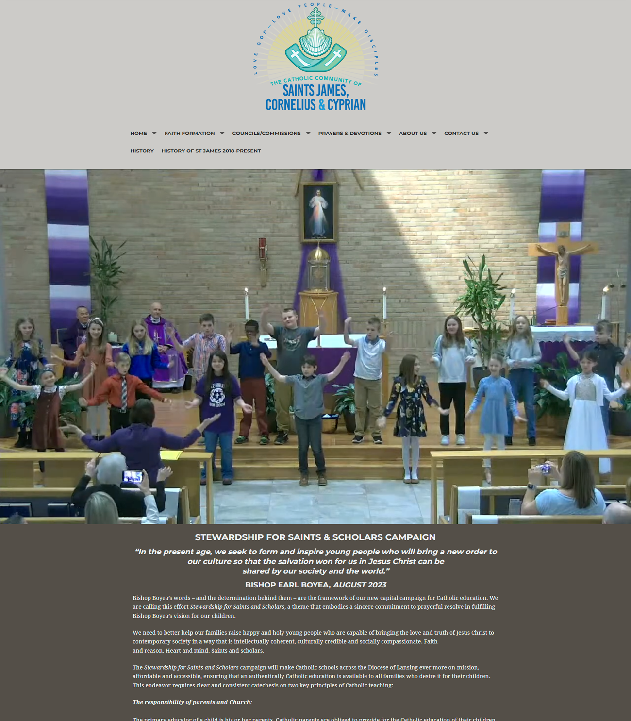 A group of children are standing in a church with their hands in the air.