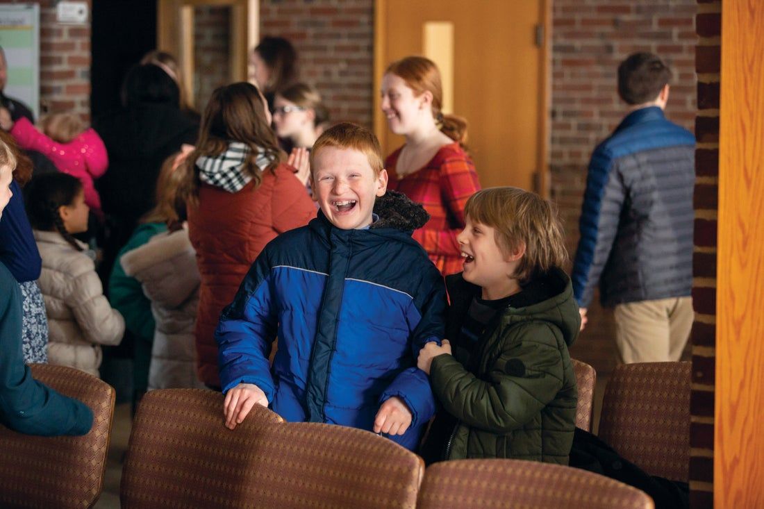A group of children are laughing in a room.
