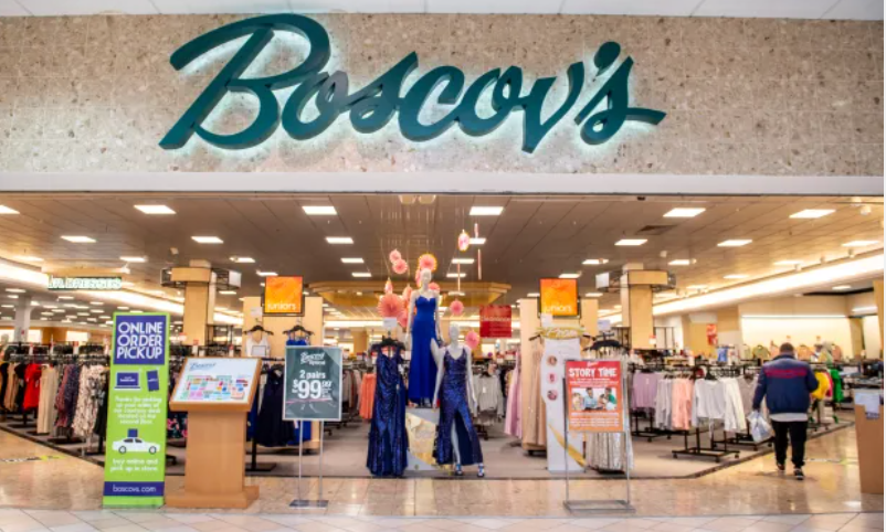 A young boy is running on a baseball field.