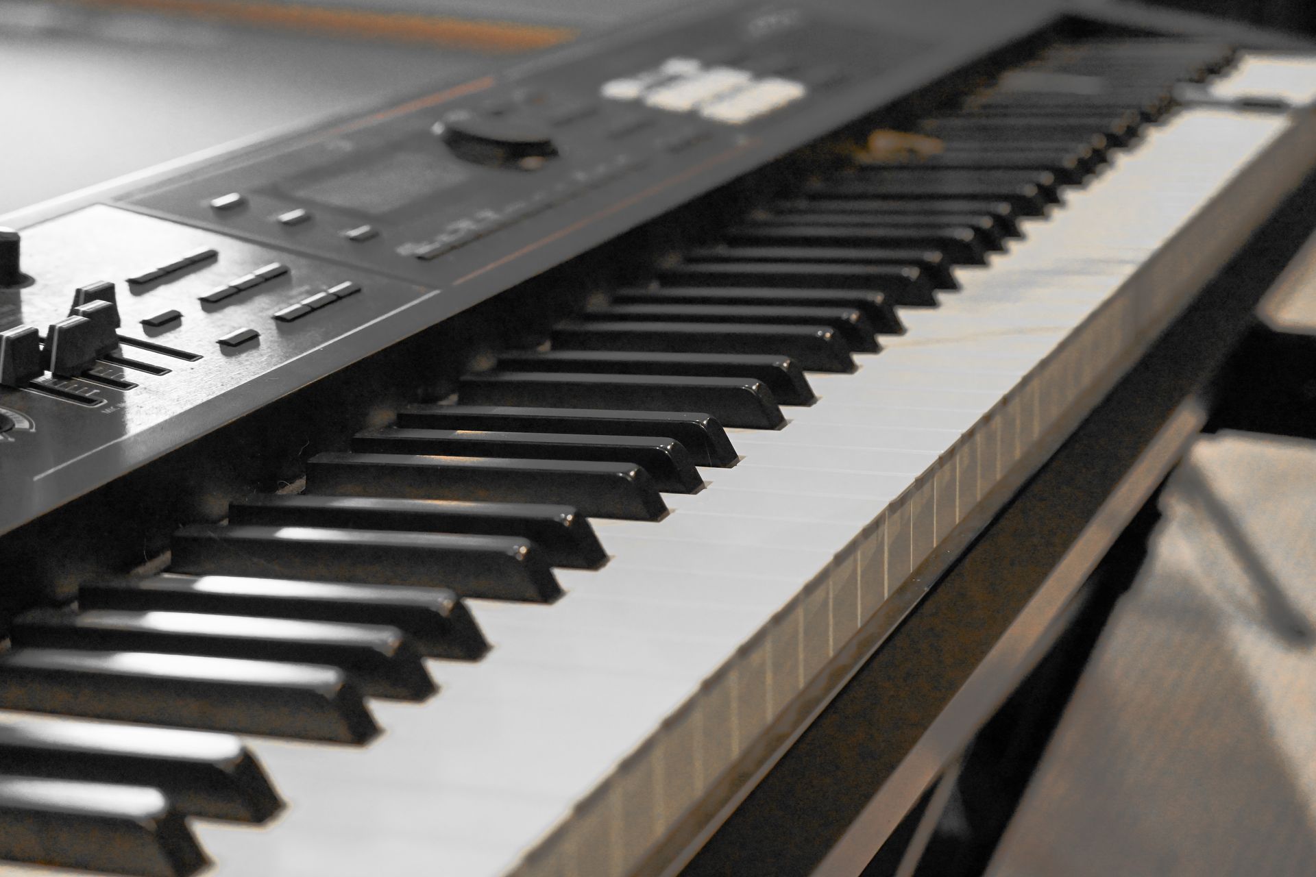 A close up of a piano keyboard on a table.