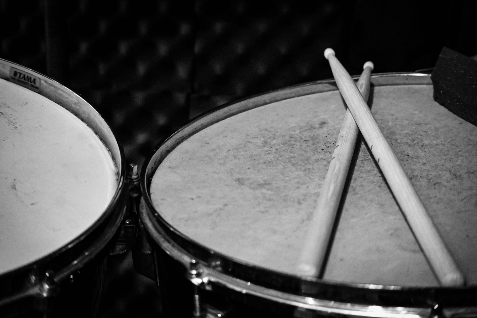A pair of drumsticks are sitting on top of a drum