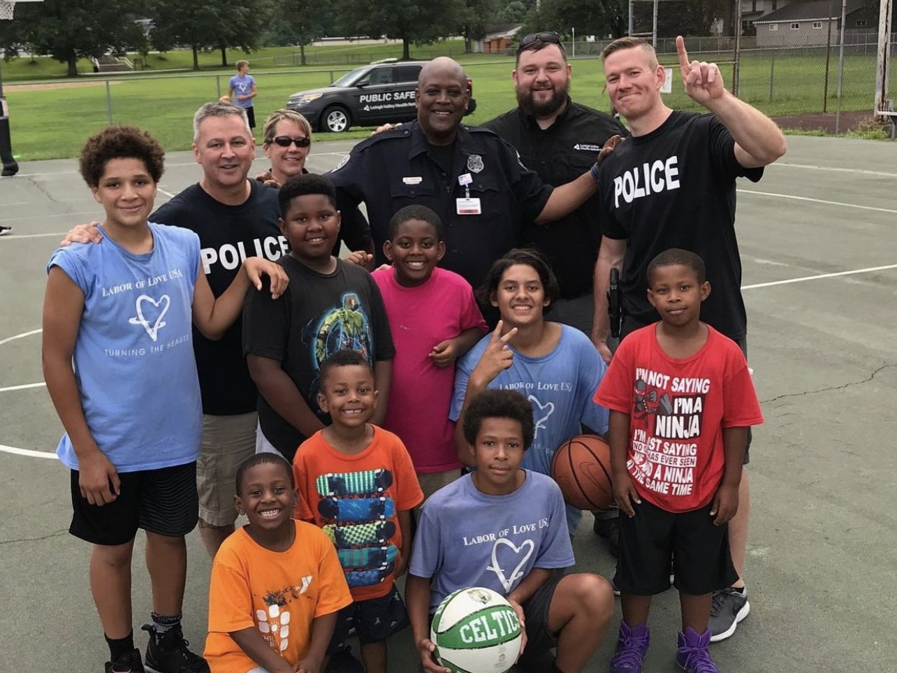 A group of children posing for a picture with police officers