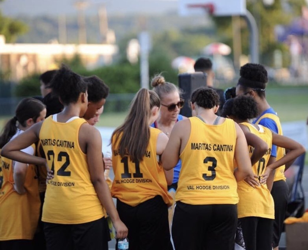 A group of people wearing yellow tank tops with the number 3 on the back
