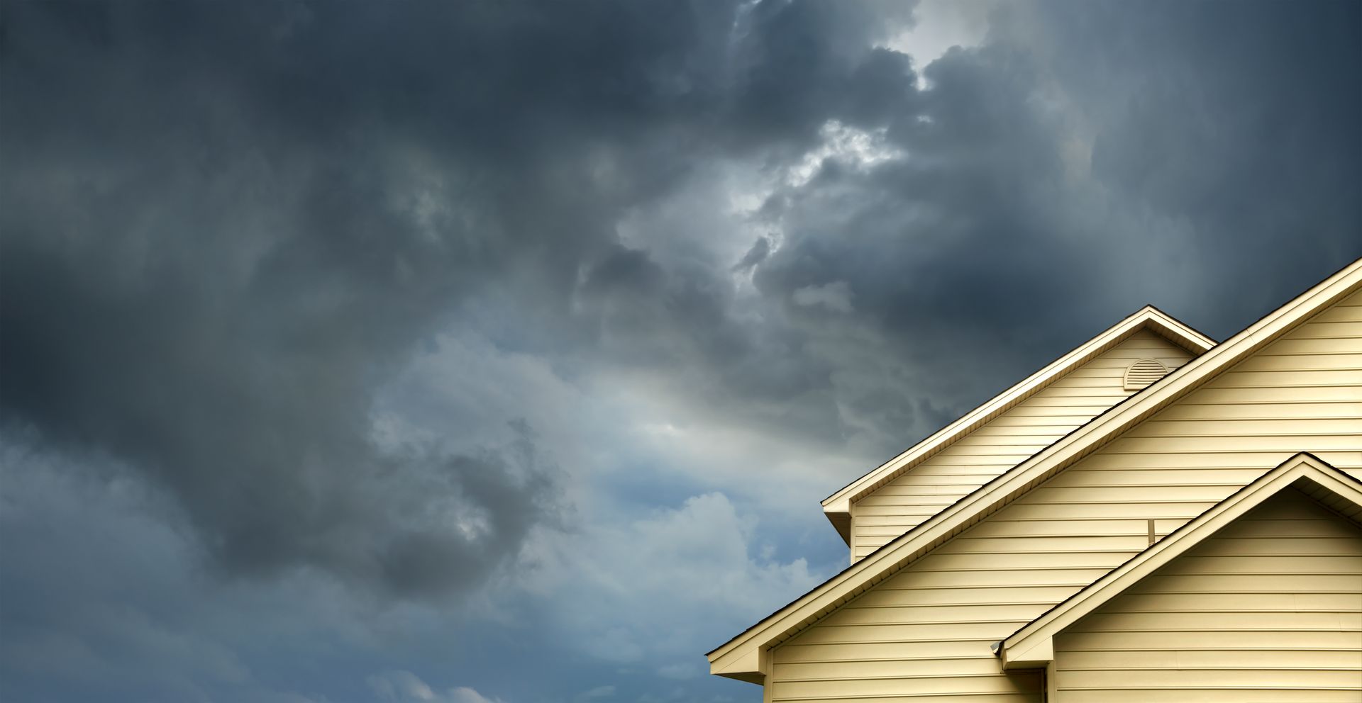 A house with a cloudy sky in the background