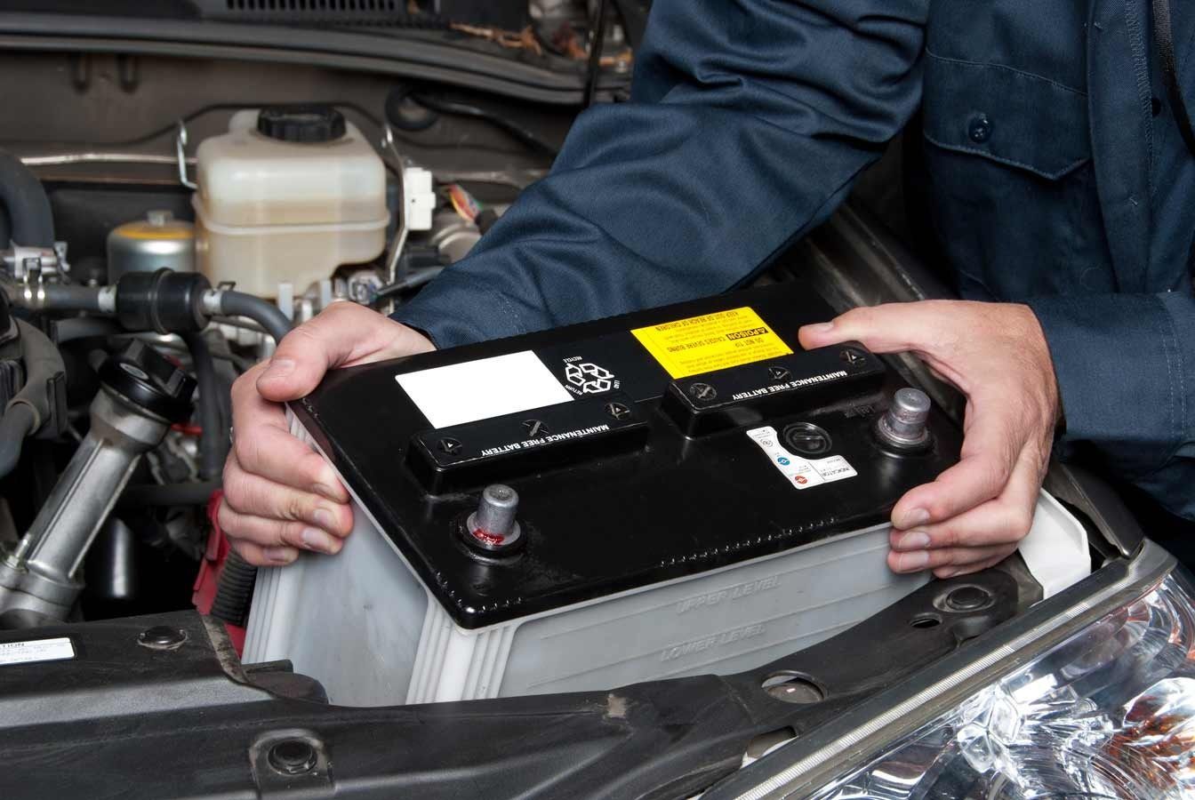 A Person is Holding a Car Battery in Their Hands — C L Dickinson Auto Electrics In Narrabri, NSW
