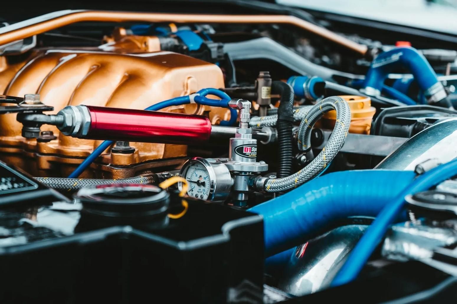 A Close Up of a Car Engine With Blue Hoses Coming Out of It — C L Dickinson Auto Electrics In Narrabri, NSW