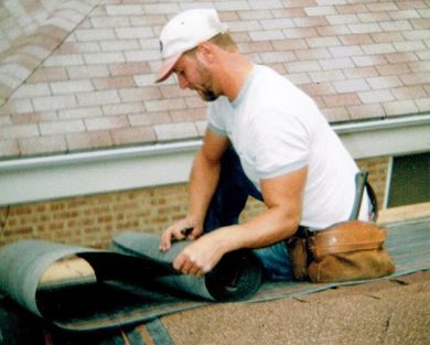 Workman Replacing Guttering On Exterior Of House — Home Improvement in Hills, IL