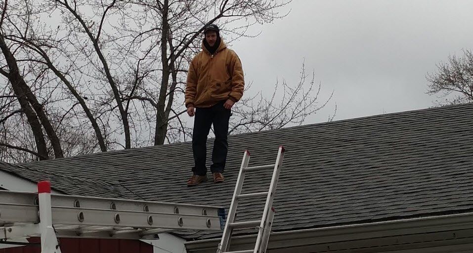 Man standing on the roof - Residential Roofing in Lake in the Hills,, IL