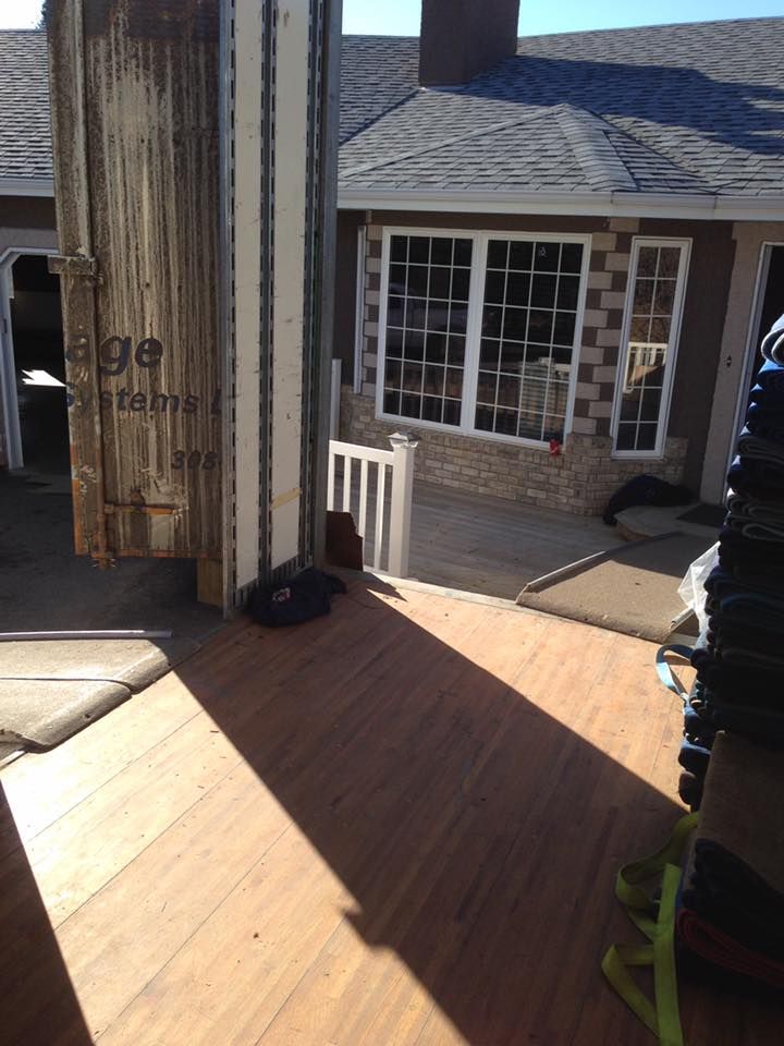 A large wooden box is sitting in front of a house