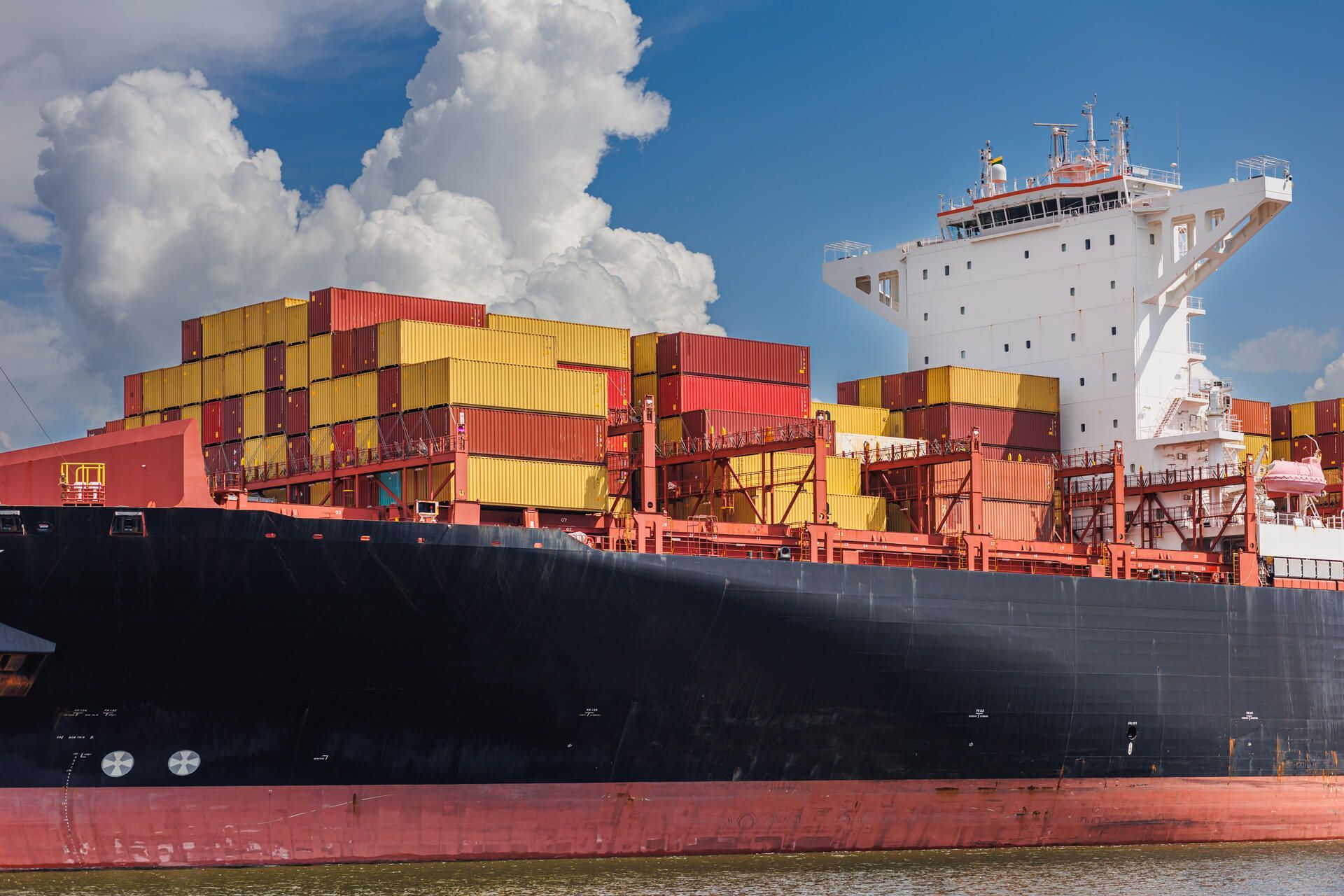 A large container ship is docked in the water