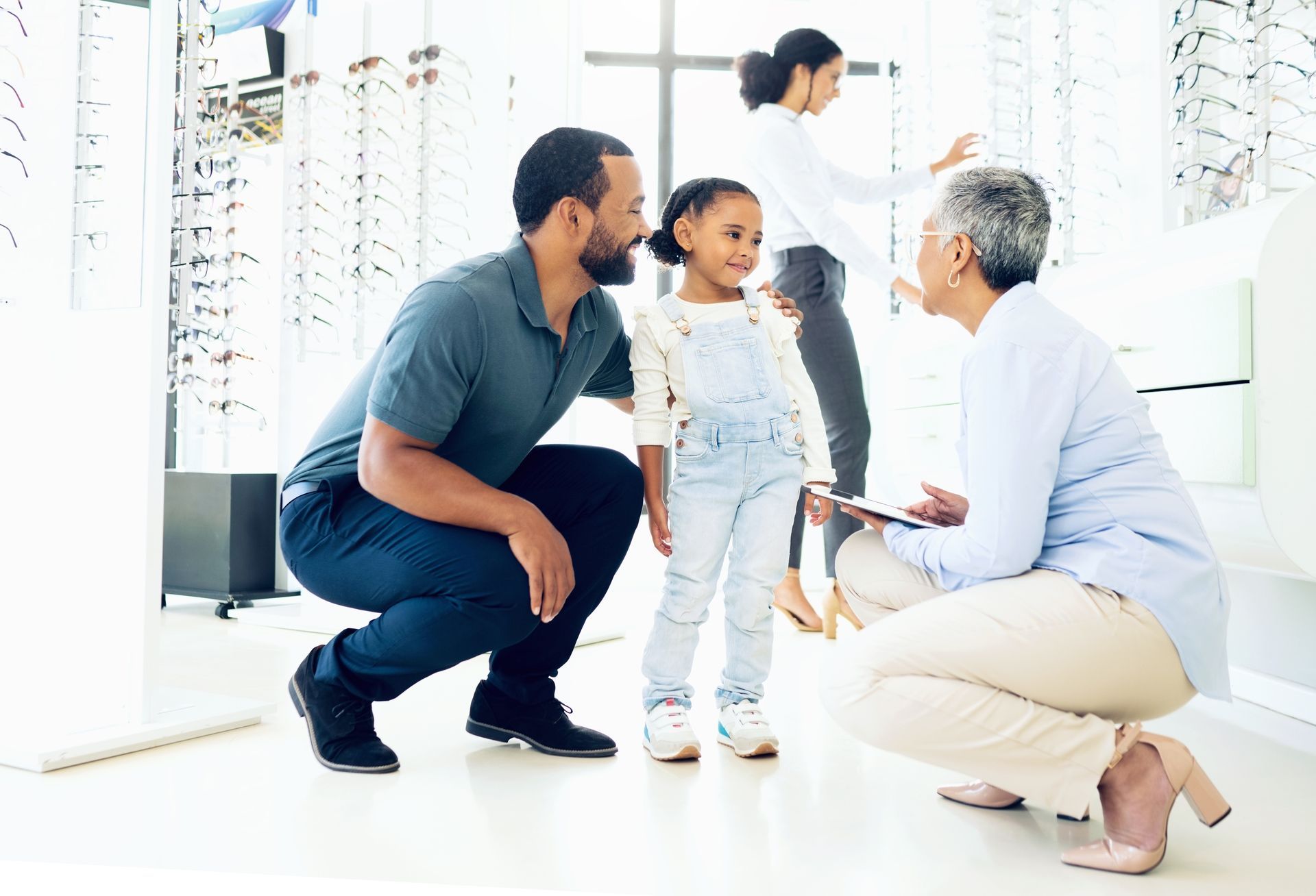 A family is looking at glasses in an optical store.