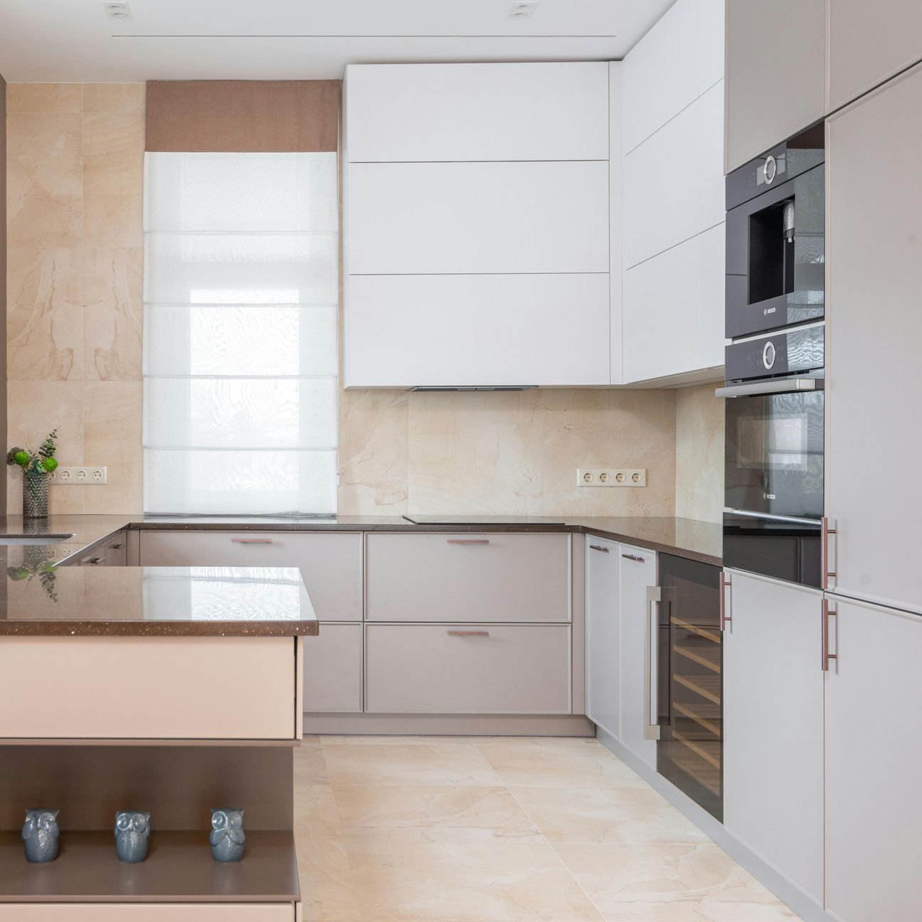 A kitchen with white cabinets and black appliances