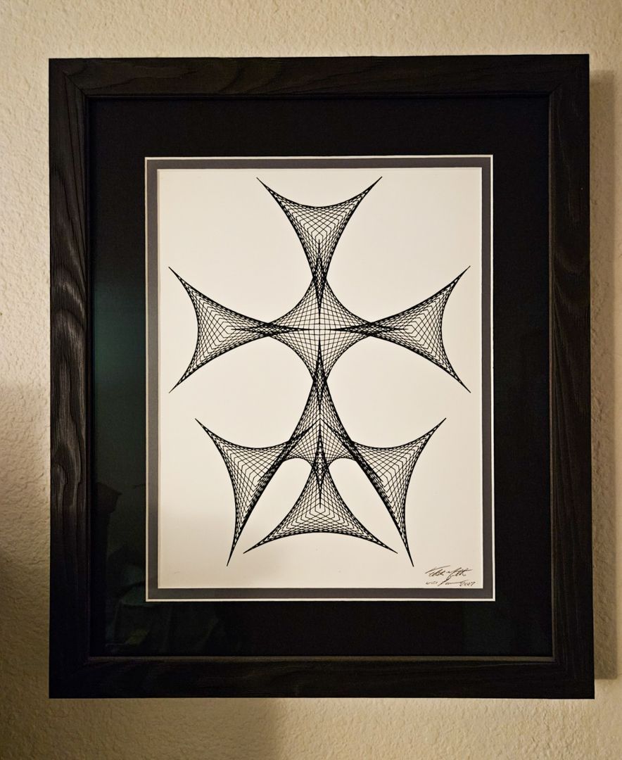 A black and white drawing of a cross in a black frame