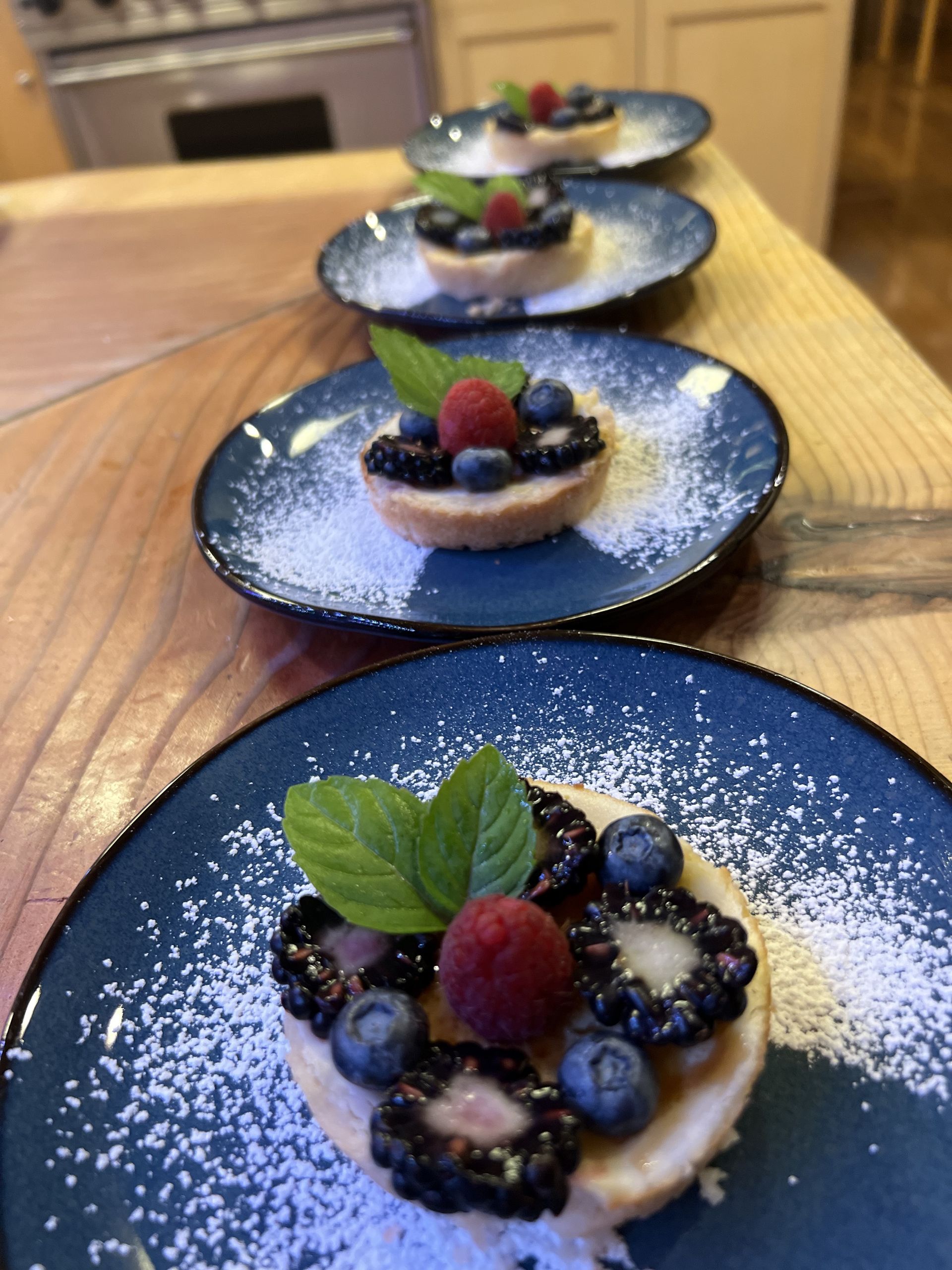 A row of blue plates with desserts on them