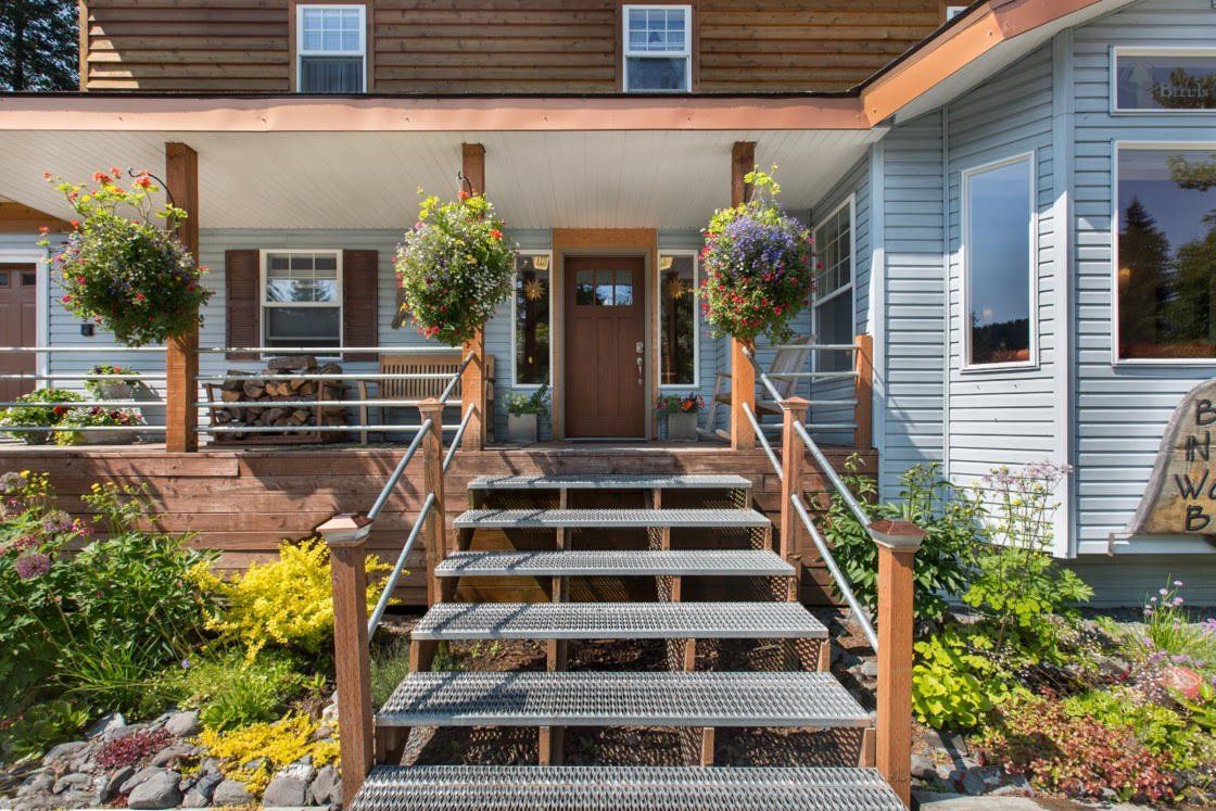 Bell In The Woods Bed & Breakfast front entrance. Terrace  surrounded by flowers in the summertime.