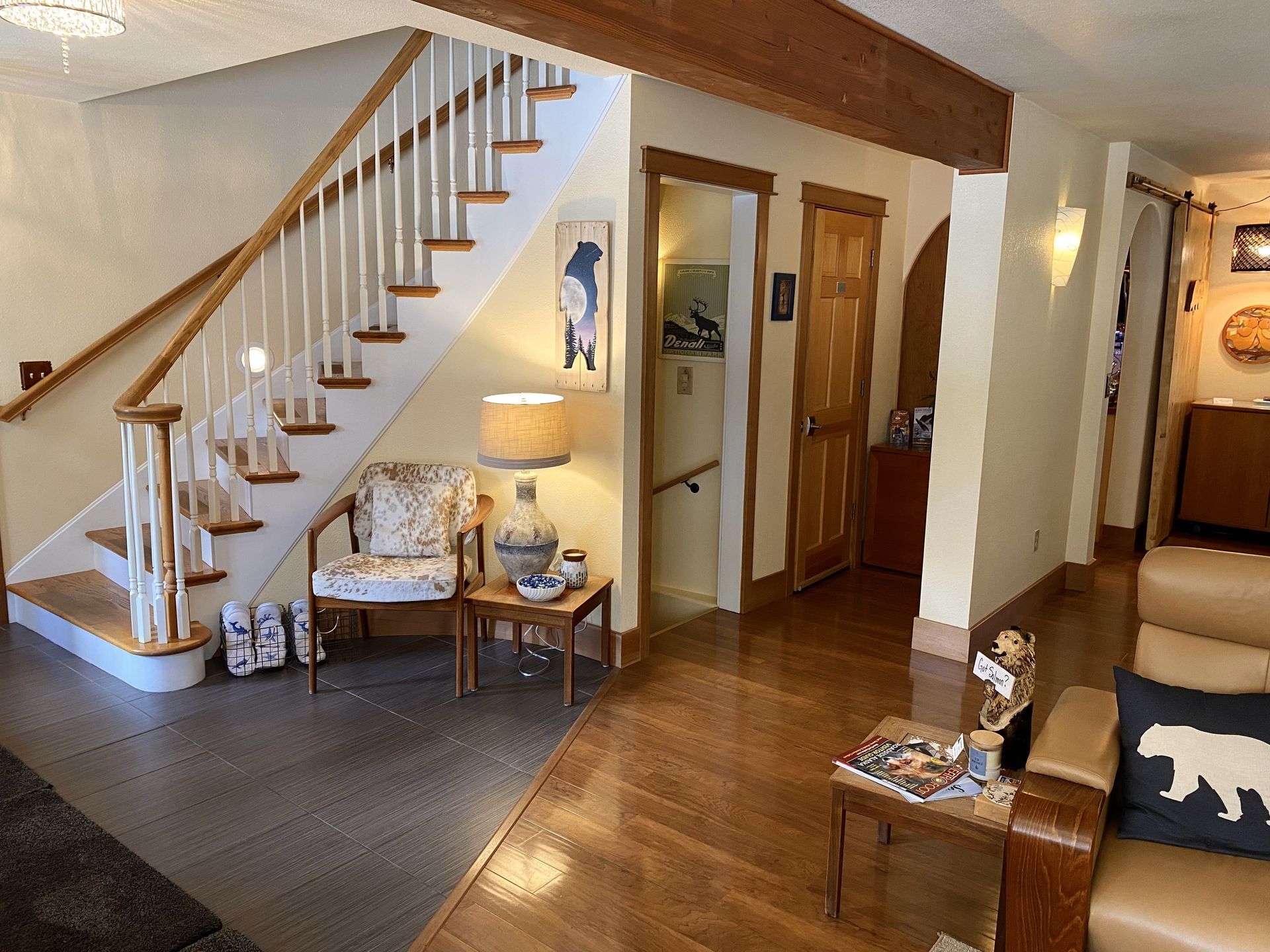 A living room with a staircase leading up to the second floor