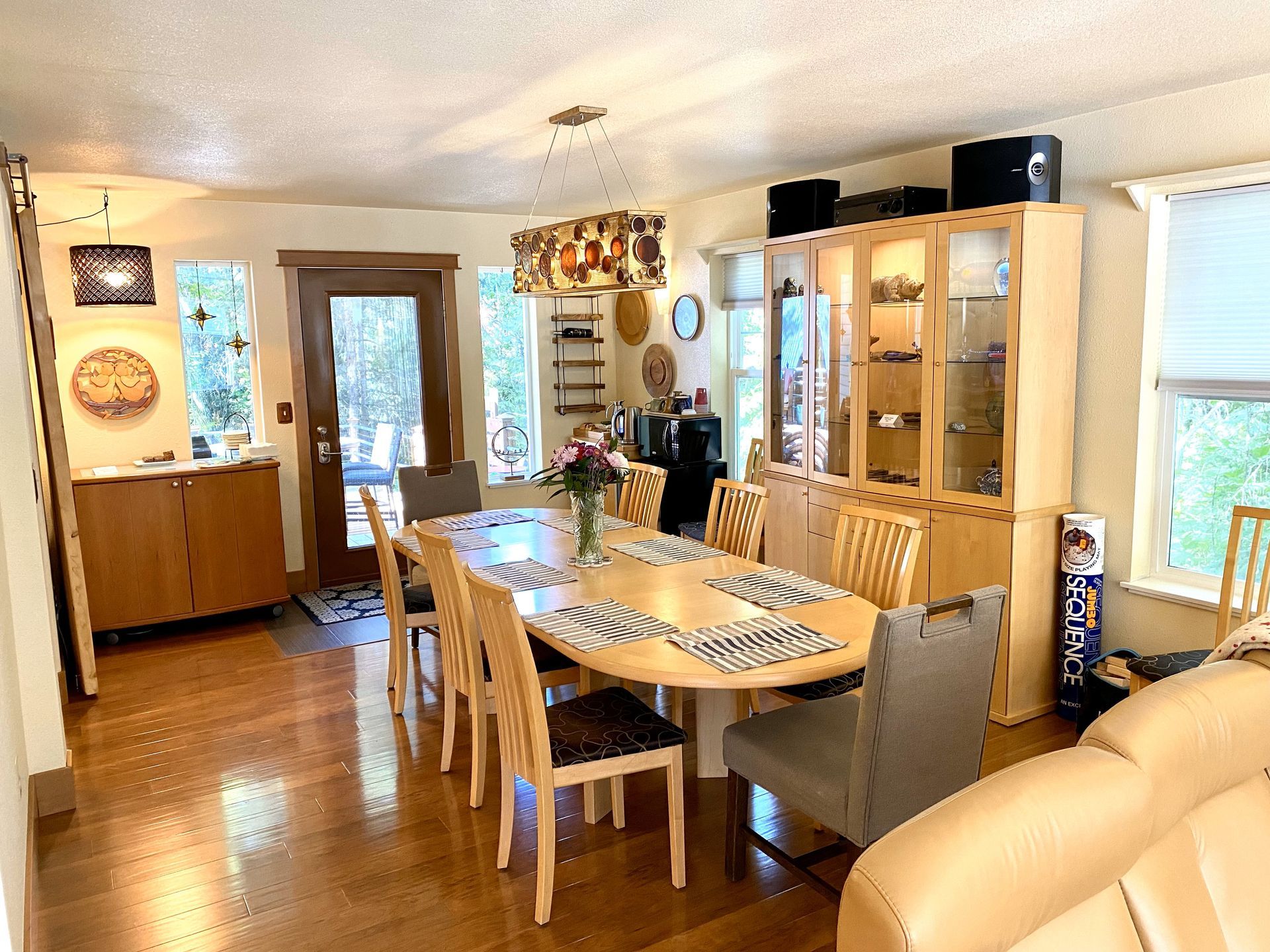 A living room with a dining room table and chairs