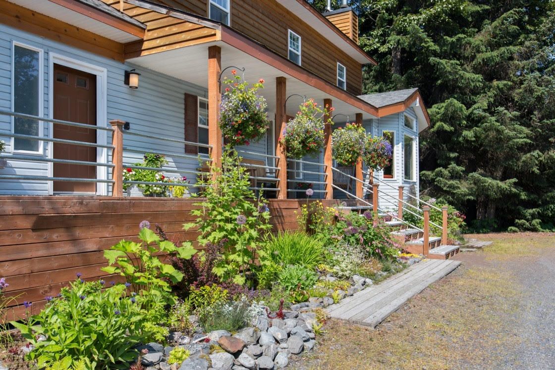 Bell In The Woods Bed & Breakfast front entrance. Terrace  surrounded by flowers in the summertime.