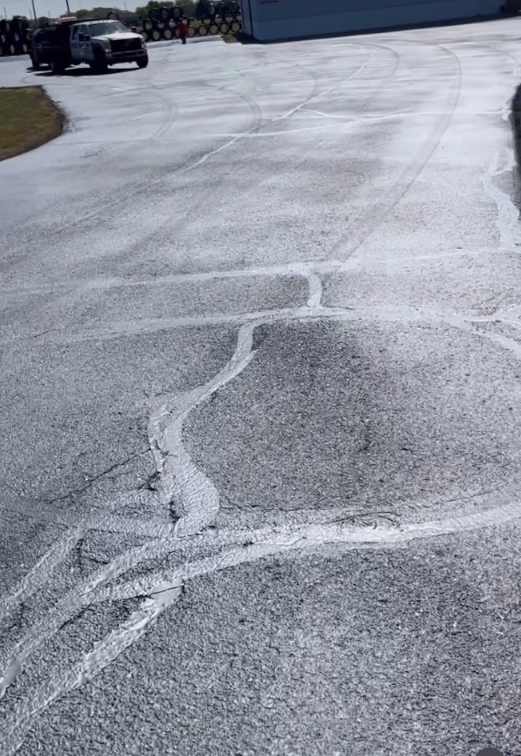 A car is driving down a road with a white line on it.