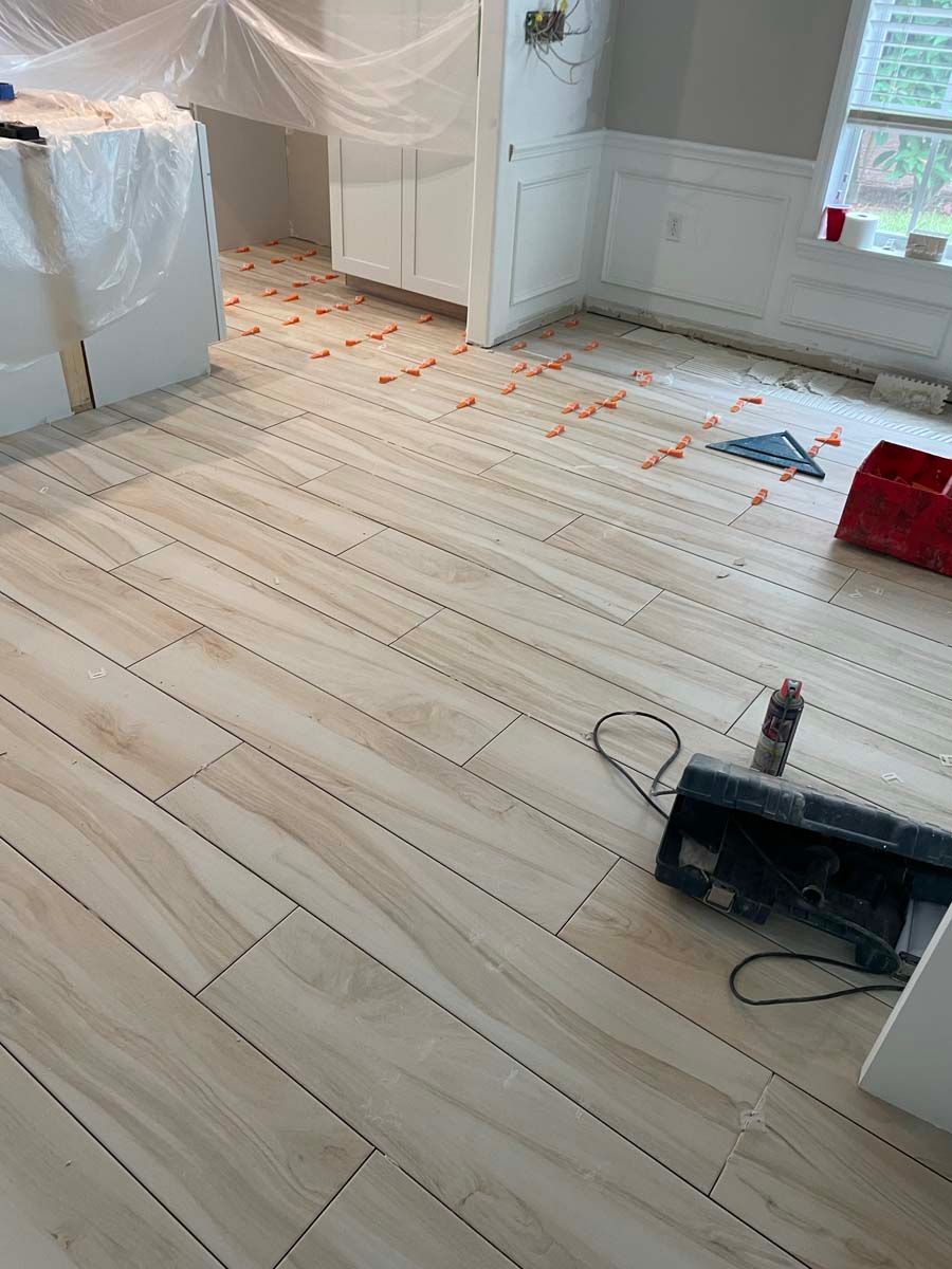 A wooden floor is being installed in a room.
