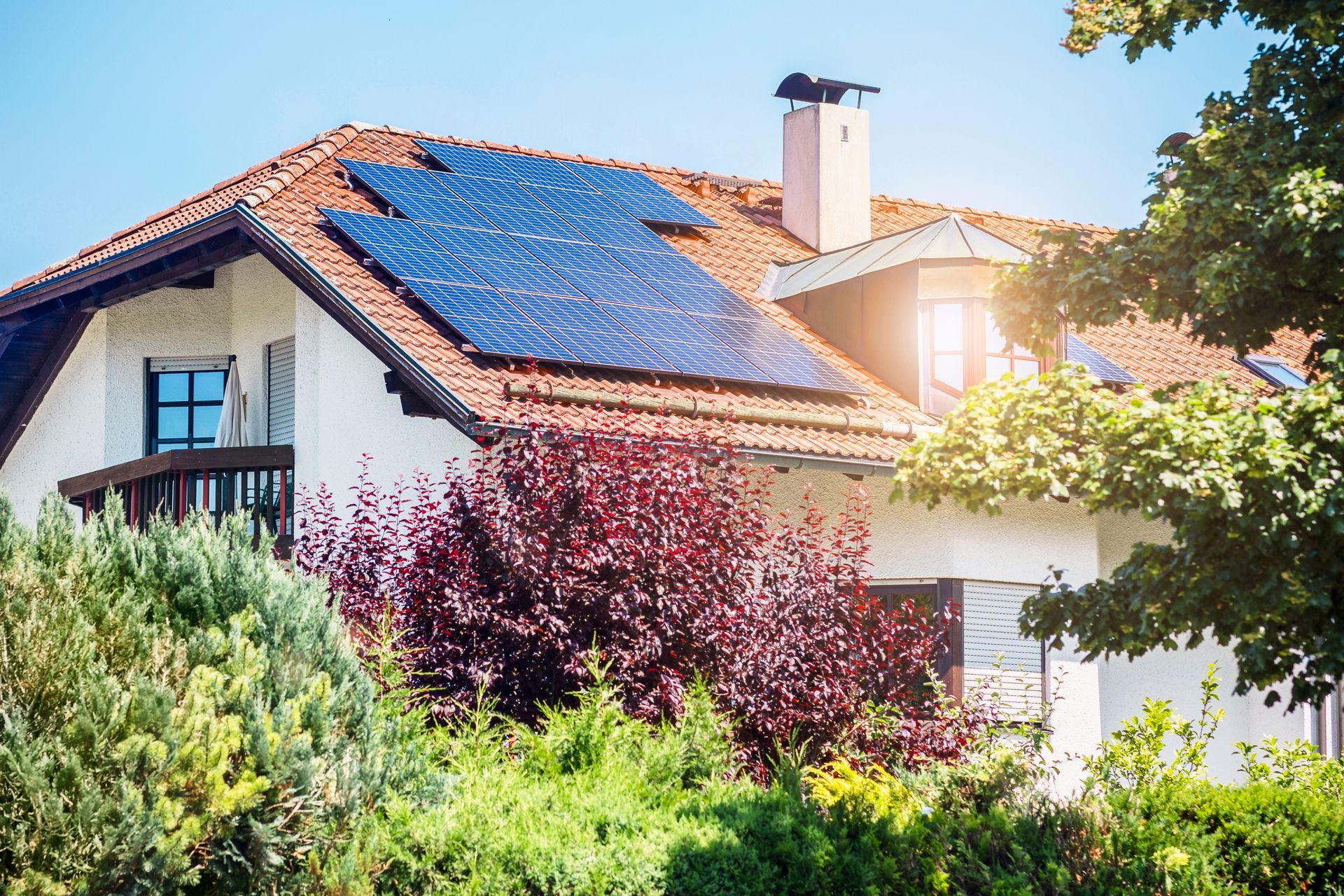 A red house with solar panels on the roof
