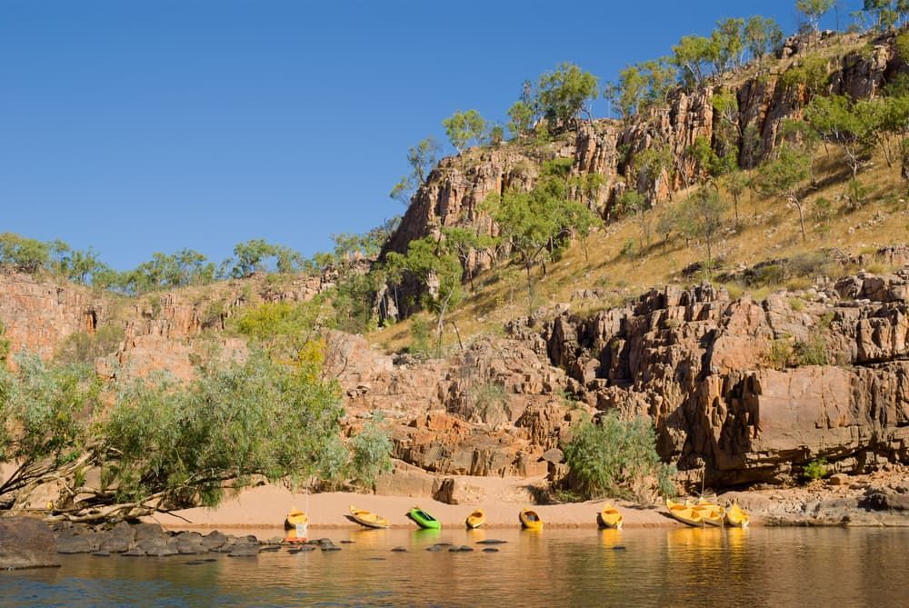 A Group Of Kayaks Are Floating On Top Of A Body Of Water - Comprehensive Security Services in Katherine, NT