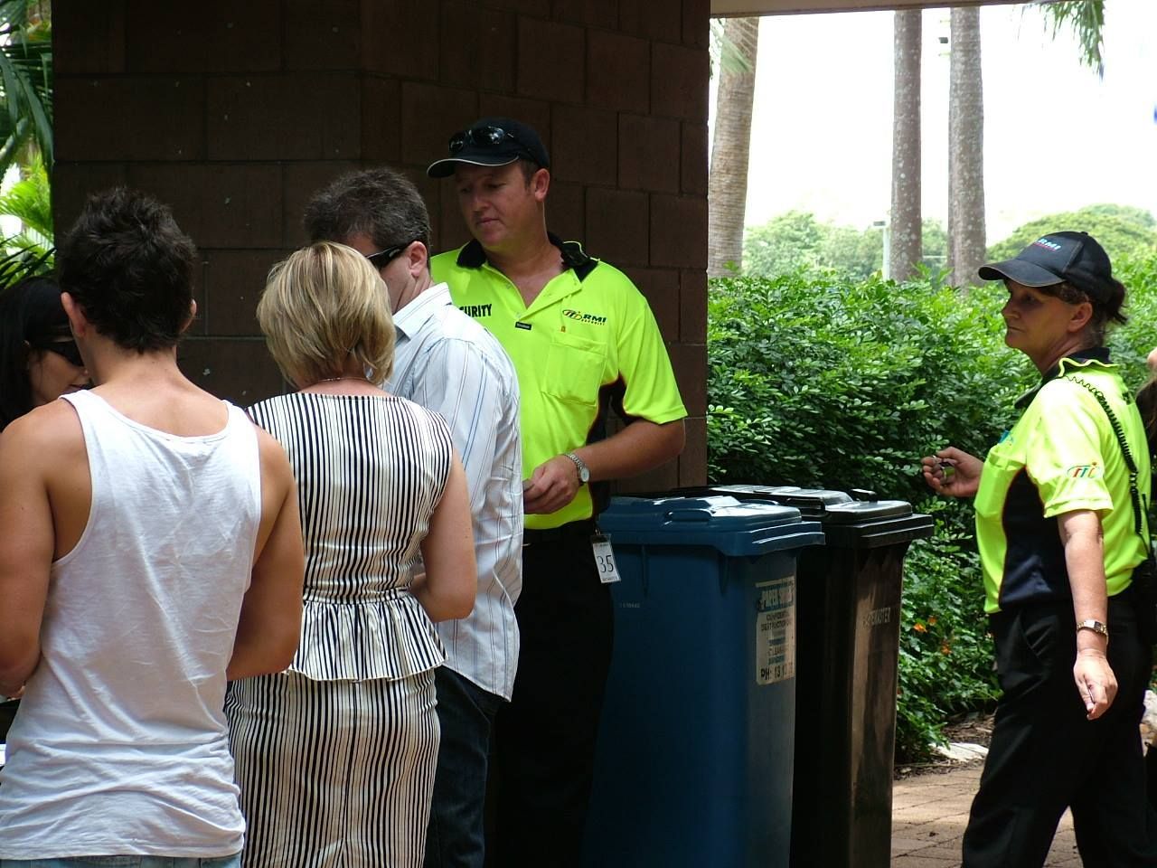 Two Security Guards Are Standing In Front Of A Building - Comprehensive Security Services in Darwin, NT