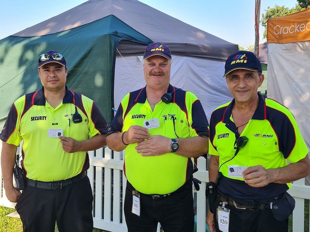 Three Men Are Standing Next To Each Other In Front Of A Tent - Comprehensive Security Services in Darwin, NT