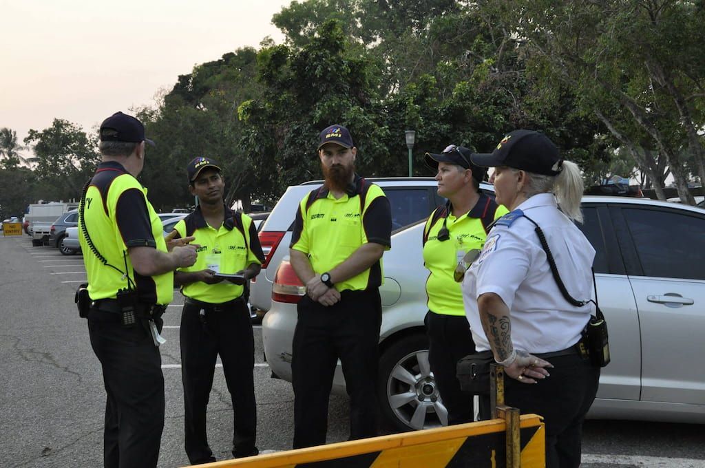 Two Police Officers Standing In Front Of A Taxi - Comprehensive Security Services in Darwin, NT
