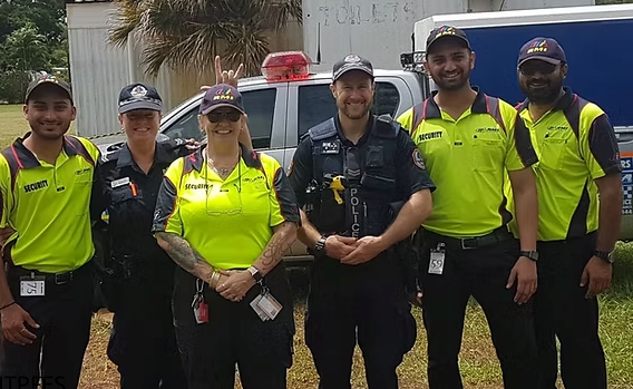 Two Police Officers And Two security Guards Standing Next To Each Other In A Line In Front Of A Police Car - Comprehensive Security Services in Darwin, NT