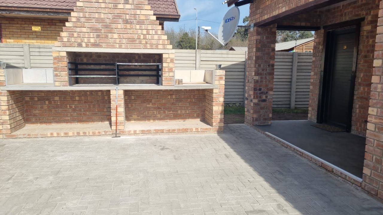 A brick building with a braai grill in front of it