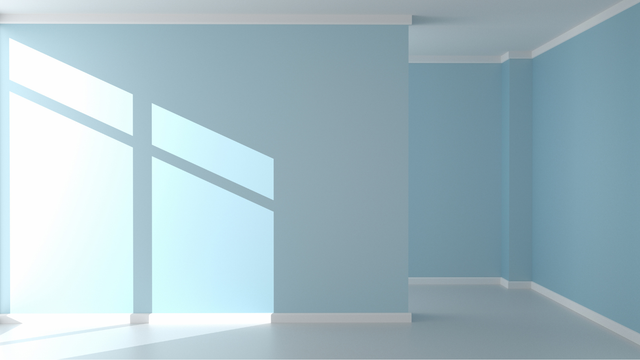 Empty room, light blue walls, white trim, and sunlight casting shadows from a window.