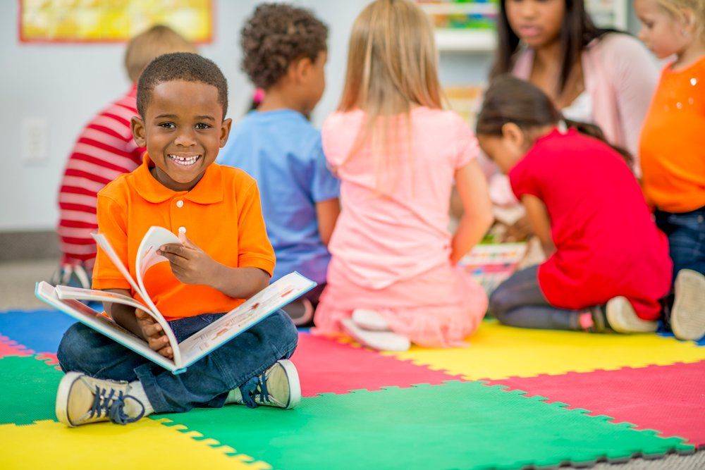 Little Boy Looking At A Picture Book — Cheyenne, WY — I Am A Promise Daycare