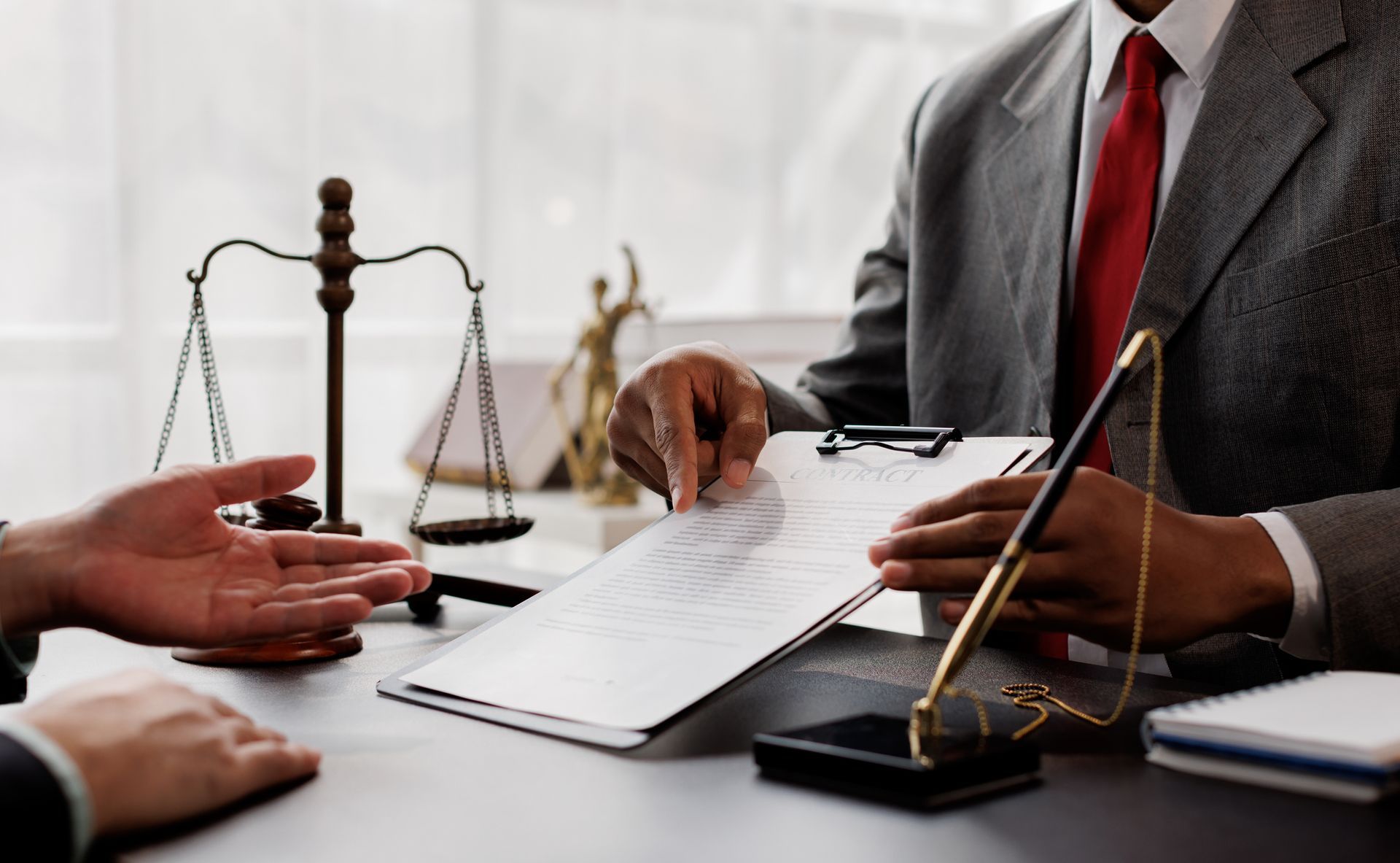 Professional divorce lawyer explaining legal documents to client in meeting.