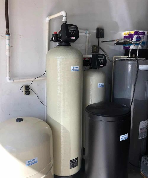 A water treatment system is installed in a garage.
