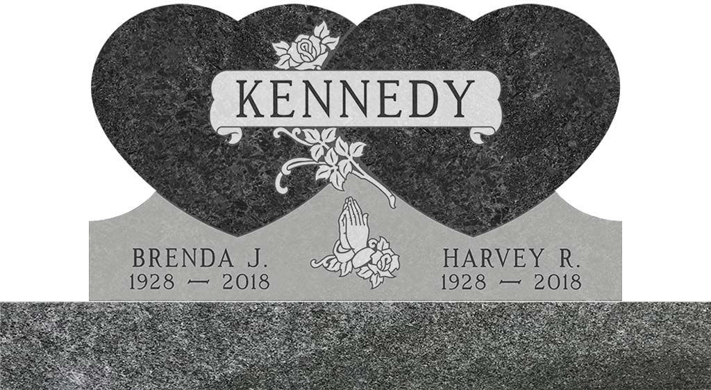 Kennedy memorial gravestone with two black heart plaques and names Brenda J. and Harvey R. with dates beneath