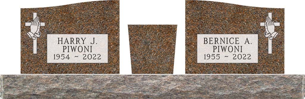 Three brown granite gravestones with white plaques in a snowy cemetery.