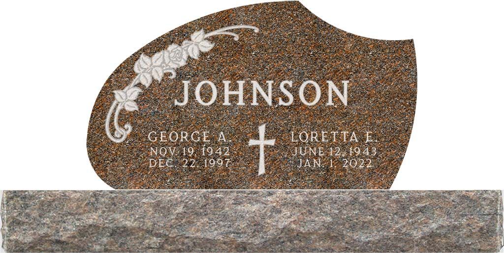 Brown granite memorial headstone with white floral engraving and the name Johnson