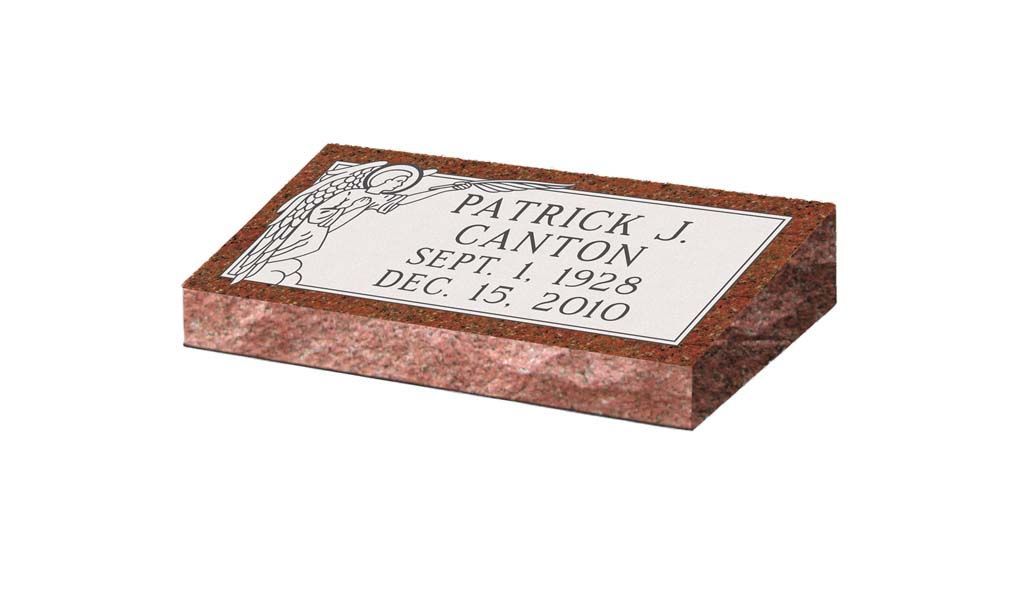Brown rectangular brick with a white engraved memorial plaque