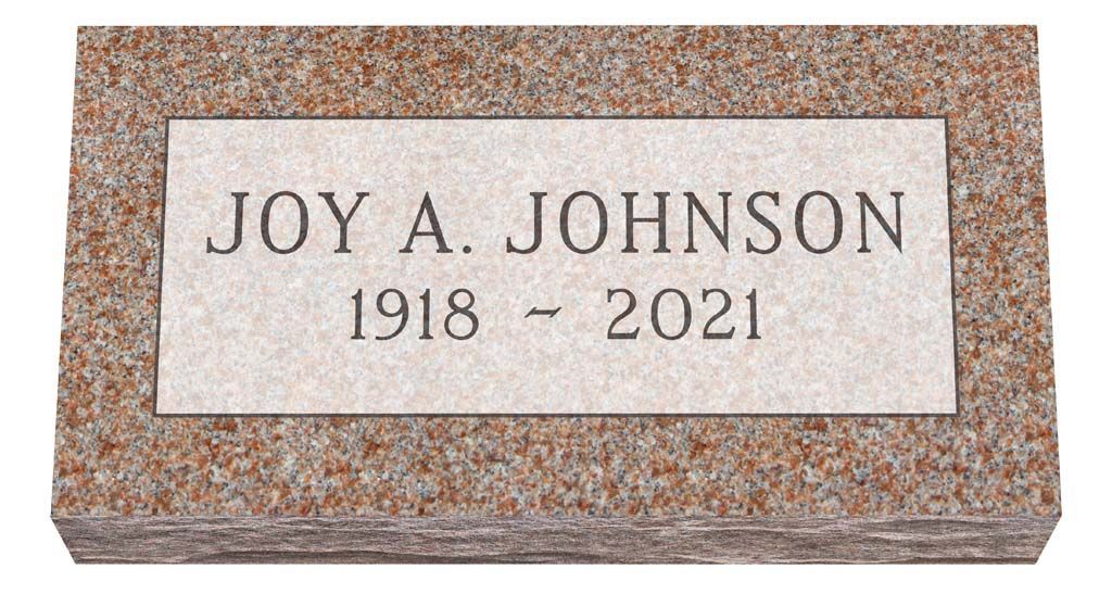 Gravestone plaque reading “JOY A. JOHNSON 1918–2021” on a speckled stone marker