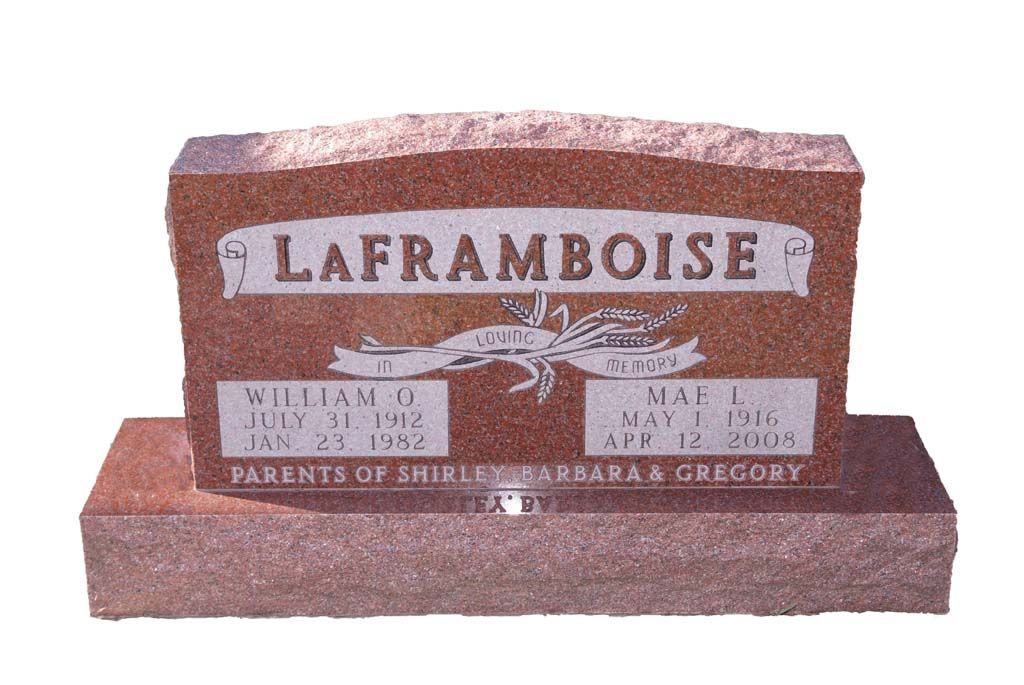 Pink granite gravestone engraved “LAFRAMBOISE” with a cross and family names