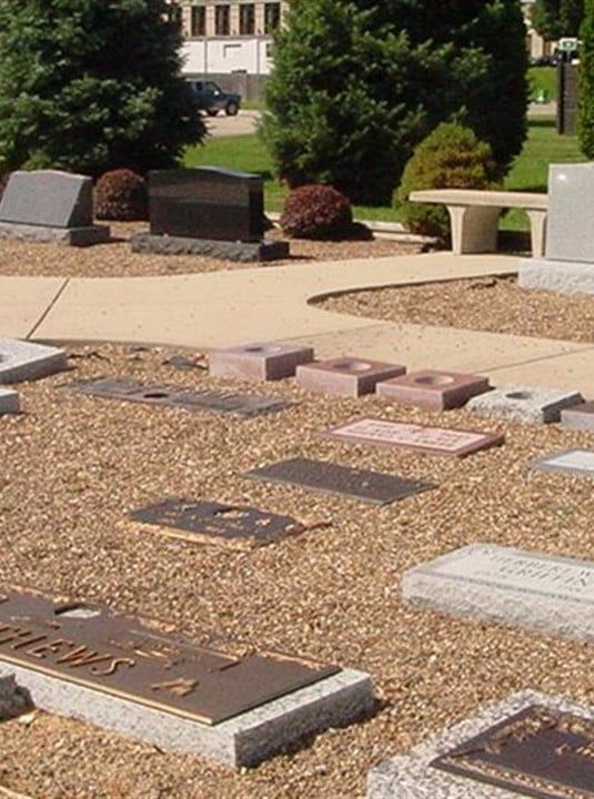 Graves in a cemetery with one that says ' james ' on it