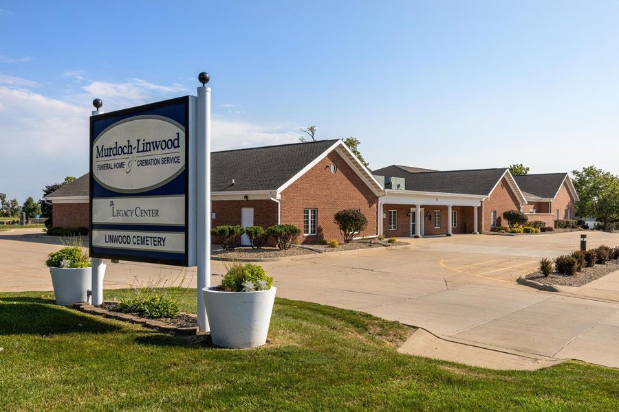 A large brick building with a sign in front of it.