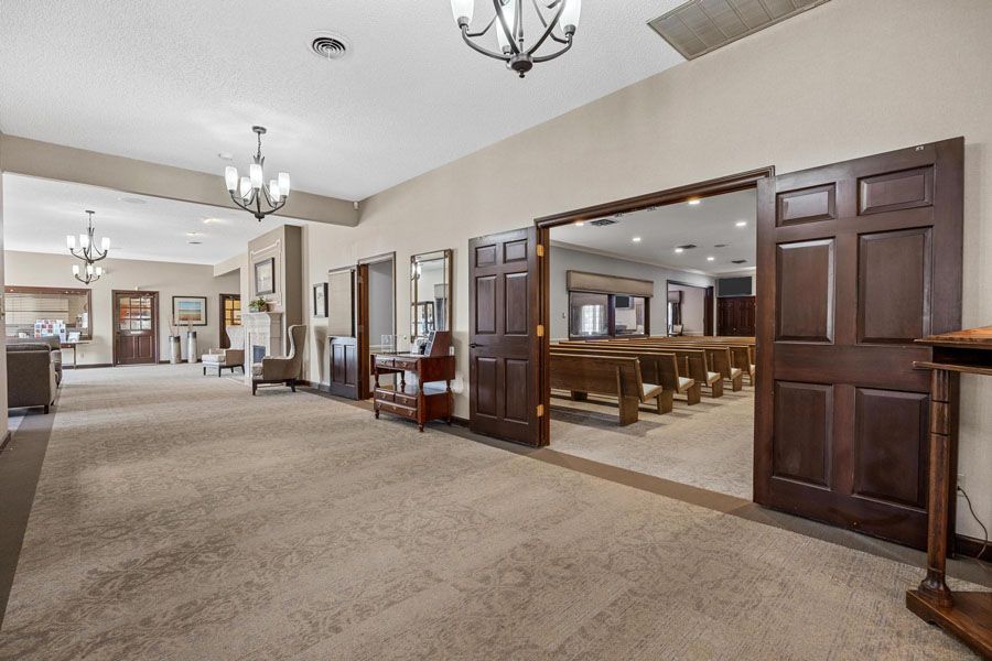 A large room with a lot of doors and a church in the background.