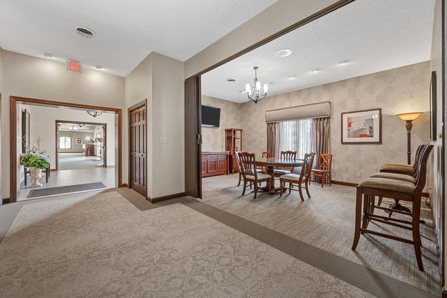 A large room with a table and chairs in it.